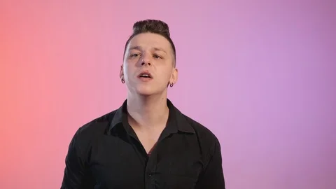 Portrait of young man looking at camera with different colors at background Stock Footage 115069615