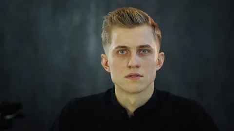 Portrait of a young man looking at the camera and excitedly answers the question 動画素材 131548779