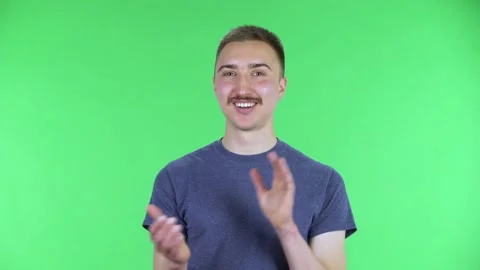 Portrait of a young man looking at the camera clapping hands with enthusiastic Stock-Footage 147487558