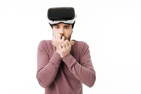 Portrait of young man looking in camera with virtual reality glasses on his head Stock Photos