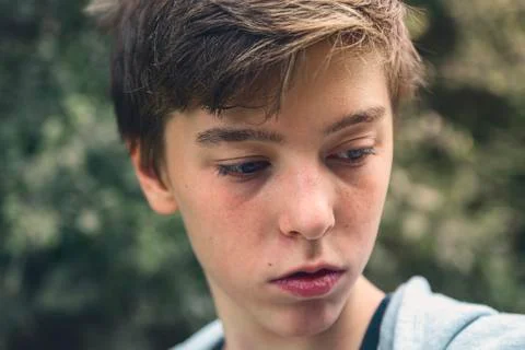 Portrait of a young man looking down, lost in thought Stock Photos