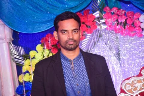 Portrait of a young man in a marriage function wearing black blazer and jeans Stock Photos