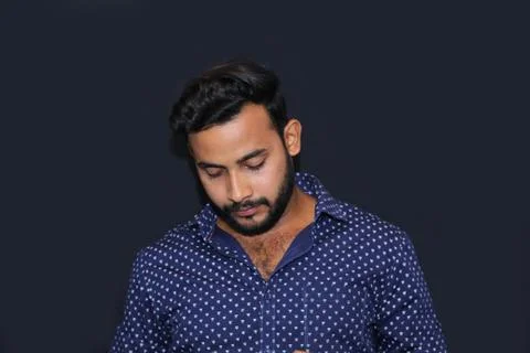 Portrait of a young man model down earth face with black background Stock Photos