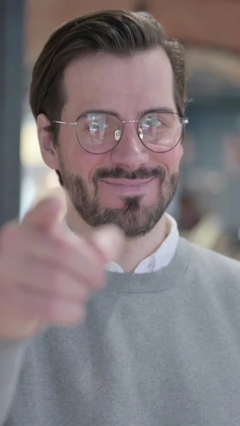Portrait of Young Man Pointing at the Camera and Inviting, Vertical Video Stock-Footage 339581327