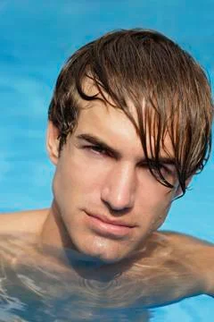 Portrait of young man in pool Stock Photos