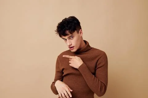 Portrait of a young man posing in brown sweater self confidence fashion Stock Photos