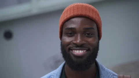 Portrait of young man posing for camera and smiling while walking in modern city Stock Footage 163815575
