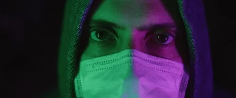 Portrait of a young man with protective mask, wearing a hoodie Stock Footage 126357943