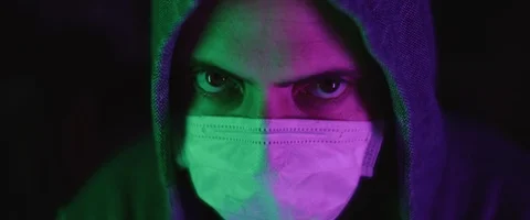 Portrait of a young man with protective mask, wearing a hoodie Stock Footage 126357946