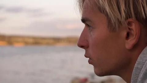 Portrait of a young man by the river Stock Footage 114631180
