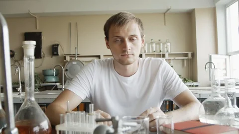 Portrait of Young man Scientist Working in Laboratory. Serious Chemist studen Stock Footage 113347831