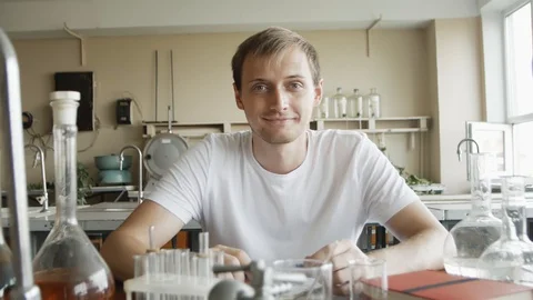 Portrait of Young man Scientist Working in Laboratory. Chemist student smilin 스톡 동영상 113347836