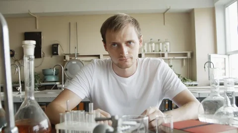 Portrait of Young man Scientist Working in Laboratory. Sad chemist student lo 스톡 동영상 113347840