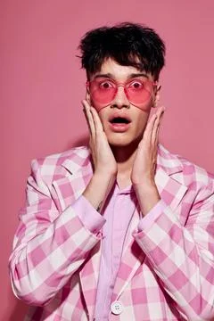 Portrait of a young man self confidence pink plaid blazer fashion posing pink Stock Photos