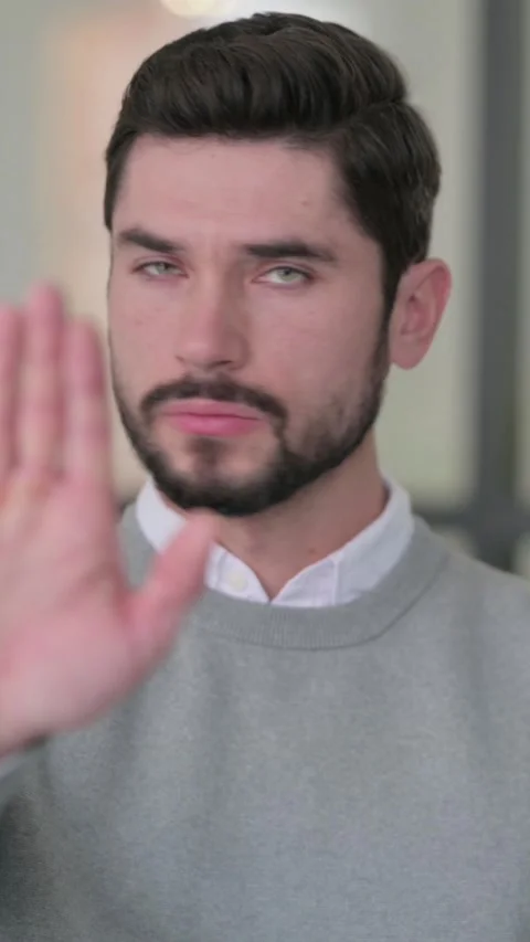 Portrait of Young Man Showing Stop Sign by Hand, Vertical Video Video stock 339583083