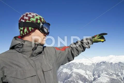 Portrait Of Young Man In Ski Wear Pointing