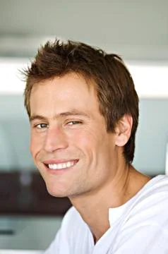 Portrait of young man smiling for the camera Stock Photos