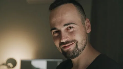 Portrait of young man started laughing on camera in living room. Stock Footage 152539710