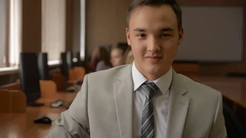 Portrait of a young man in a suit and tie smiling. Stock Footage