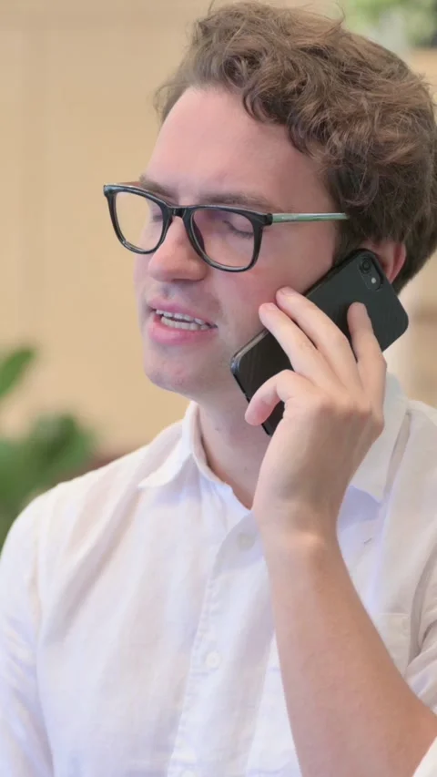 Portrait of Young Man Talking on Smartphone, Vertical Video Stock Footage 340033767