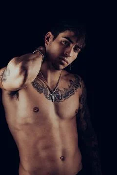 Portrait of a young man with tattoos and silver jewellery Stock Photos