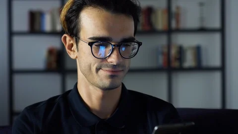 Portrait of Young Man Texting on thr Phone. Phone Screen Reflecting in the Stock Footage 93260559