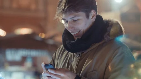 Portrait of young man using his mobile phone at night. 動画素材 71222032