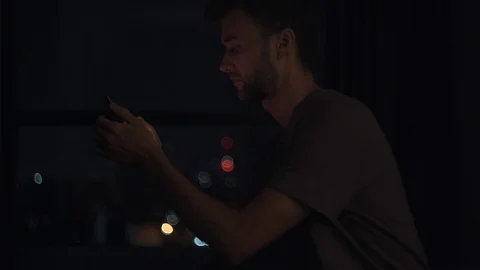 Portrait of Young Man Using his Phone  In The Office or Remote Workplace in the  Stock Footage 120359929