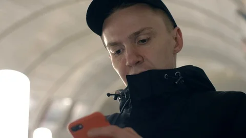 Portrait young man using mobile phone for browsing networks on metro escalato Stock Footage 86533337