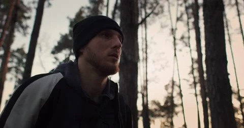 Portrait of a young man walking through the forest on sunrise. Sportsman workout Stock Footage 271731406