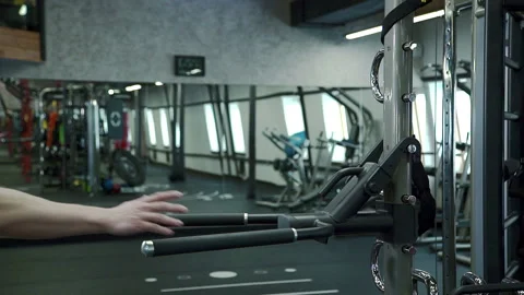 Portrait of young man, who is doing chest version of dips exercise in modern gym Video stock 88579639