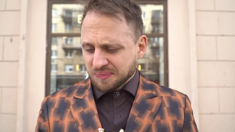 Portrait of a young man who eats a tasteless sandwich. Stock Footage 130140078