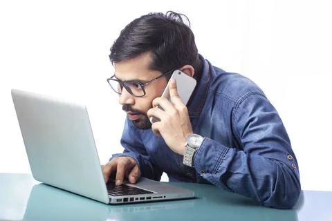 Portrait of a young man working on computer looking close to the screen 스톡 사진