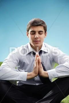 Portrait of young meditating businessman Stock Photos