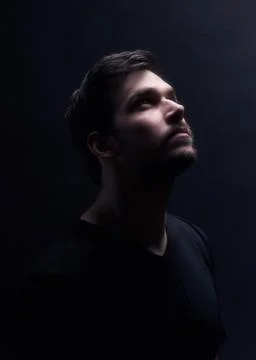 Portrait of a young men looking up. Stock Photos