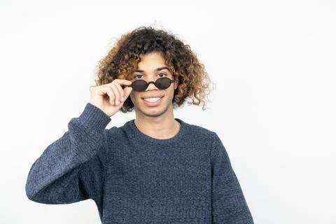 Portrait of young middle eastern man with curly hair wearing sunglasses Stock Photos