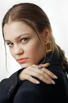 Portrait of a young model on a white background. A Caucasian girl in a black Stock Photos