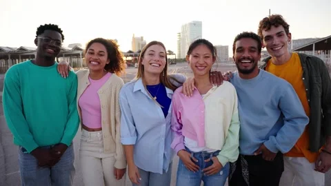 Portrait young multiracial people posing hugging and smiling looking cheerful at Stock Footage 273092113