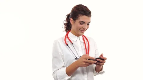 Portrait of a young nurse using her smartphone to text messages. Young medical Stock Footage 79561659