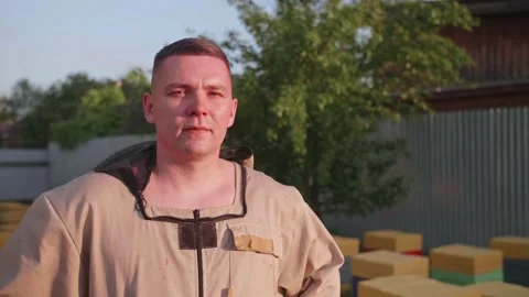 Portrait of a young owner of an apiary on which he breeds bees and extracts Stock Footage 156844574