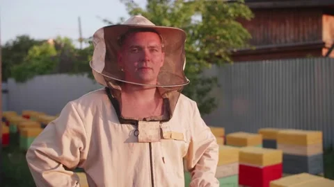 Portrait of a young owner of an apiary on which he breeds bees and extracts Stock Footage 156844850