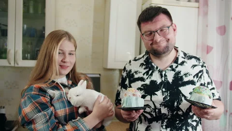 Portrait of young people celebrating Easter with rabbit and cakes Stock Footage 330500942