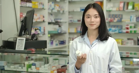 Portrait of a young pharmacist smiling at camera. Stock Footage 124230393