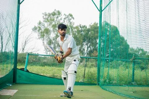Portrait of a young player getting ready to strike During a Cricket net practice Stock Photos