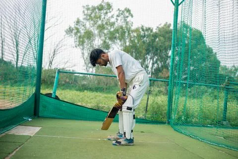 Portrait of a young player getting ready to strike During a Cricket net practice Stock Photos