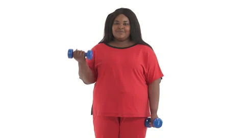 Portrait of young plus size black woman doing weight loss exercise with Stock Footage 134570260