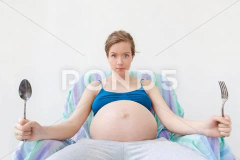 Portrait Of Young Pregnant Woman, Stomach In Focus