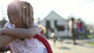 Portrait Of A Young Pretty Girl Smiling And Looking Around In A Playground Stock Footage