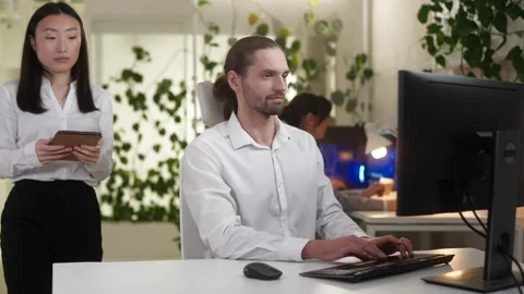 Portrait of young professional male developer coding on computer in modern Stock Footage 228980783