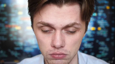 Portrait of a young professional man looking tired and exausted into the camera Stock Footage 128439778